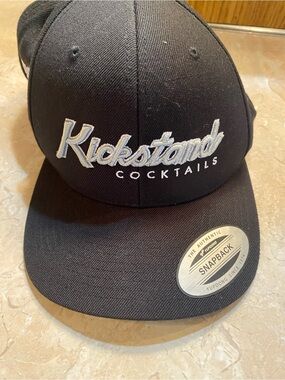 The Classic Black Snapback Hat with White 'Kickstand Cocktails' Embroidery